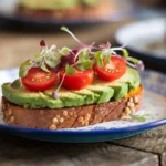 Sweet potato toast with avocado and cherry tomatoes.